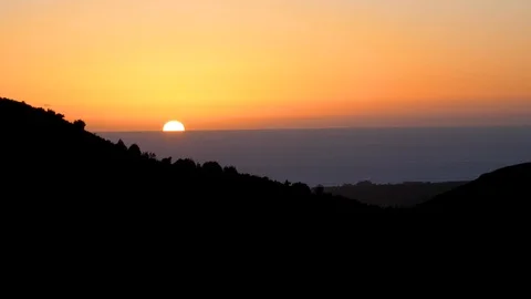 Time Lapse Sunset over horizon of ocean from surrounding mountains in Cambria Stock Footage 105765584