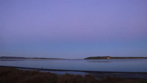 Time lapse of sunset over lake into night with stars, France Stock Footage 164534129