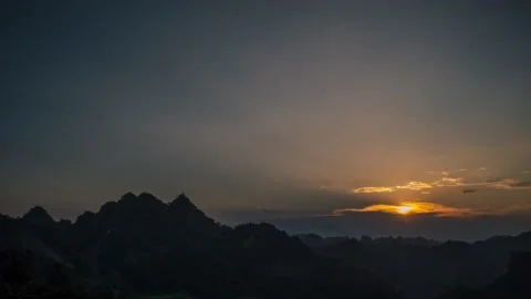 Time lapse of sunset over mountain peaks. Beautiful sky and ray light Stock Footage