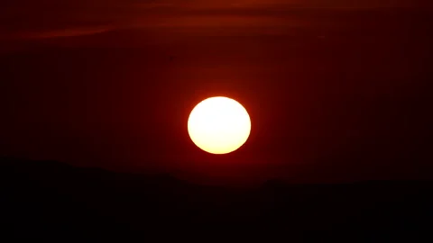 Time-lapse sunset over a mountain with colorful orange clouds Stock Footage 308455278