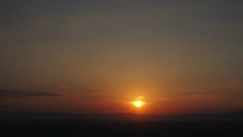 Time lapse sunset over a mountain with colorful orange clouds Stock Footage 308455330
