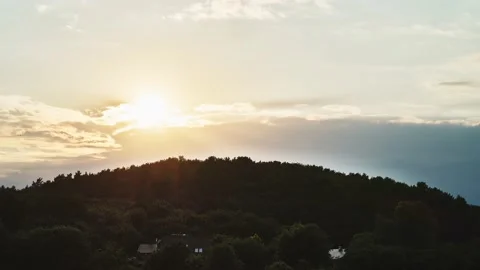 Time lapse sunset over the mountains. sun hides behind the green hill full of Stock Footage 155196822