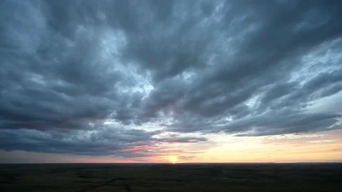 Time lapse of a sunset over prairie badlands with teal blue to orange clouds Stock Footage 221502484