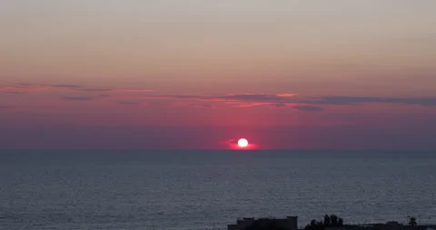 Time lapse of sunset over the sea in front of Paola Stock Footage 161594638