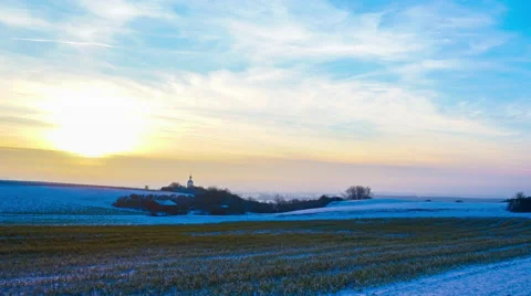 Time-lapse of a sunset over a winterly landscape Stock Footage 63211999