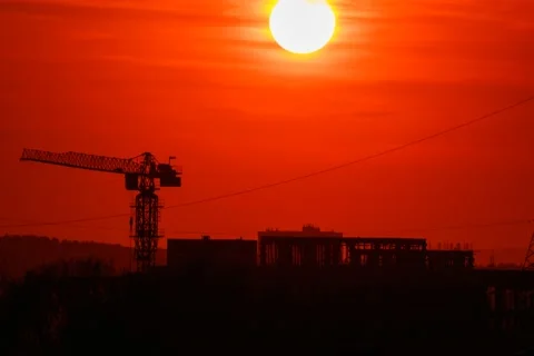 Time lapse sunset of red sun over a city with lines of clouds skyline and Stock Footage 131451281