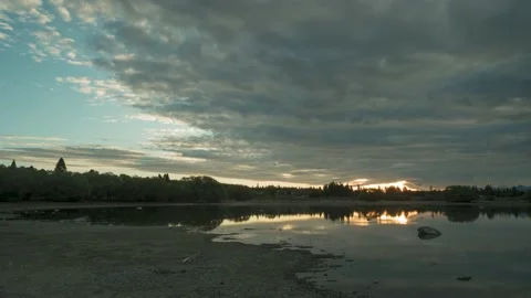 Time-lapse of a sunset reflected in Lake Tekapo, New Zealand. Stock Footage 146190803