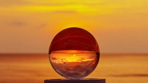 Time lapse Sunset Refraction in Crystal Ball Stock Footage 336102689