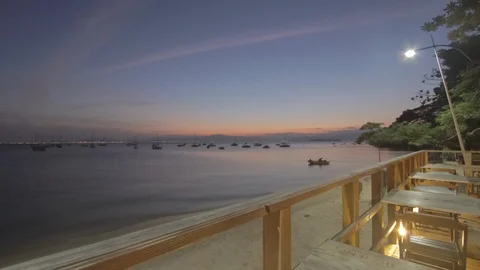 Time lapse - Sunset at a restaurant in the beach. Dolly shot 2K Stock Footage 88929253
