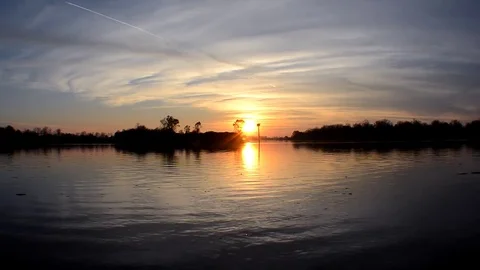 Time Lapse of Sunset on River with Clouds Stock Footage 73780635