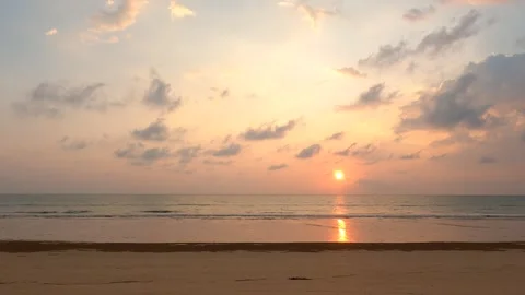 Time lapse of sunset sky over sea and silhouette people walking on the beach Stock Footage 306335110