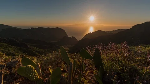 Time lapse sunset, the sun goes down behind the island Stock Footage 125128772
