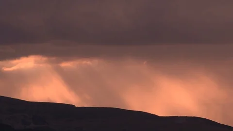 Time lapse of sunset sun rays through the clouds. Mountain silhouette. Heavy Stock Footage 91446221