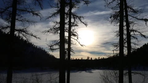 Time-lapse Sunset Through Clouds Over Snow Covered Lake  WS Stock Footage 50542720