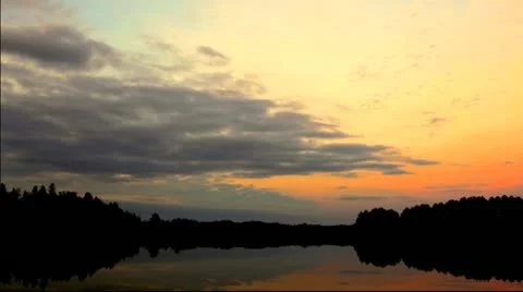 Time Lapse: Sunset in vibrant colors over a forest lake Stock Footage 12661337