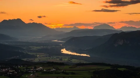 Time Lapse - Sunset view down the mountain into the valley with clouds moving Stock Footage 99360838