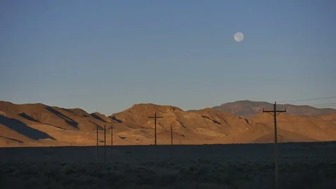 Time Lapse-Supermoon sinks lower in morning sky over Cricket Mountains Stock Footage 69883232