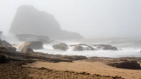 Time lapse of surf crashing on rocks and a beach. Mist fills the background Stock Footage 46939383