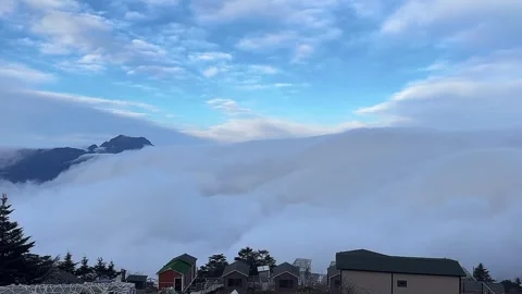 Time Lapse of Thick Sea of Clouds Rolling Over Mountain Ridge and Vacation H Stock Footage 333285511