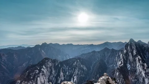 Time Lapse of Thin Cloud Flowing Layered Peak Distant View Stock Footage 337938208