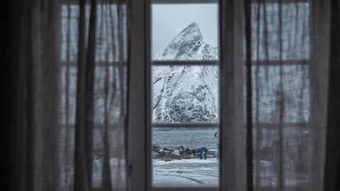 Time lapse through a window of a snowy mountain in Lofoten, Norway. Stock Footage 125404488