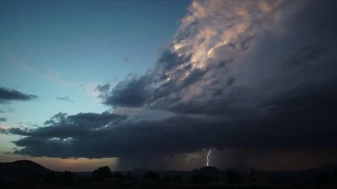 Time lapse of thunderstorm rolling over landscape Stock Footage