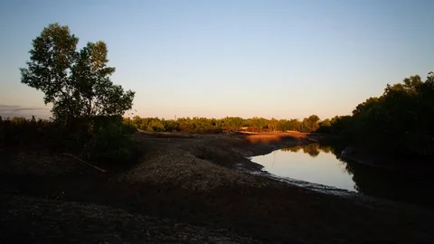 Time lapse at a tidal canal with dug-out canoes at sunrise in Madagascar 動画素材 70146321