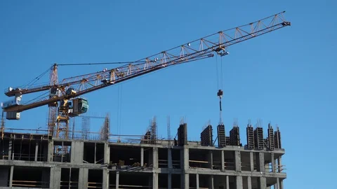 Time lapse tilt shift builders and industrial cranes working on construction. Stock Footage 129663388