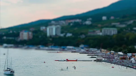 Time lapse, tilt shift effect. Public beach with vacationers, tourists, cafes Stock-Footage 221358445