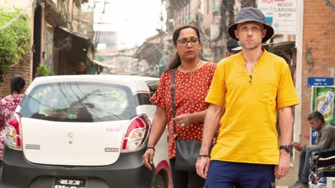 Time lapse of tourist man dressed yellow shirt standing on nepalese crowded narr Stock Footage 337650571