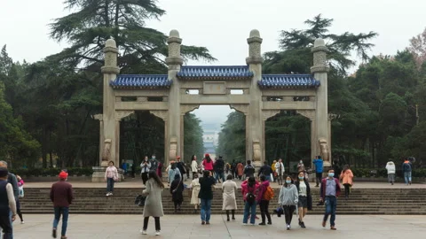 Time lapse of tourists across memorial archway at Dr. Sun Yat-Sen Mausoleum Stock Footage