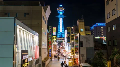 Time-lapse of tourists walking through Shinsekai at night Stock Footage 310950931