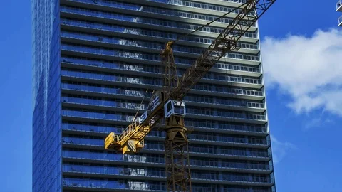 Time lapse of tower crane spinning on sunny day. Stock Footage 128463702