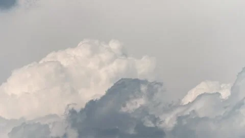 Time lapse of towering cumulus clouds illuminated by soft natural light against Video stock 340542829
