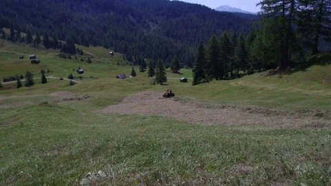 Time lapse tractor wheel collecting hay, Alta Badia Stock Footage 79010355