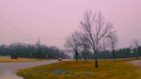 Time-lapse traffic at a 4 way intersection blurred motion stormy day. Stock Footage 158863023