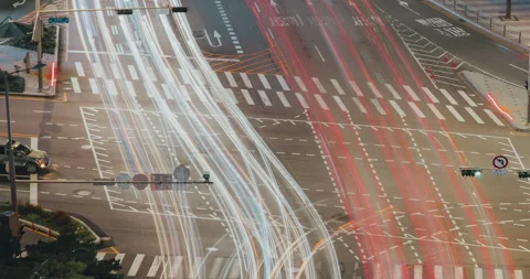 Time-lapse. Traffic flows through a busy intersection at night, showcasing the Stock Footage 327133533