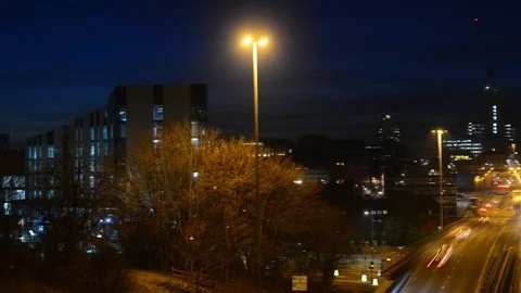 Time lapse of traffic headlight trails and leeds city skyline at twilight uk Stock Footage 103632698