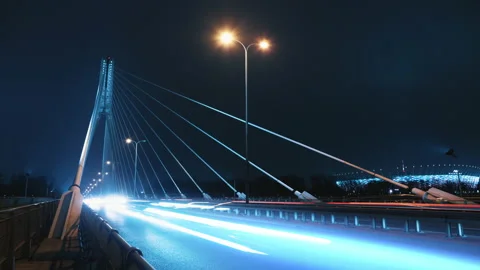 Time lapse traffic jam on city bridge road at night, car lights trail Stock Footage