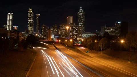 Time lapse of traffic light streaks on a freeway in front of downtown Atlanta Stock Footage 99600889