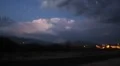 Time lapse traffic with a lightning storm backdrop over mountains Video HD