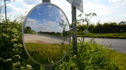 Time lapse traffic passing roadside convex safety mirror united kingdom Stock Footage 50750184
