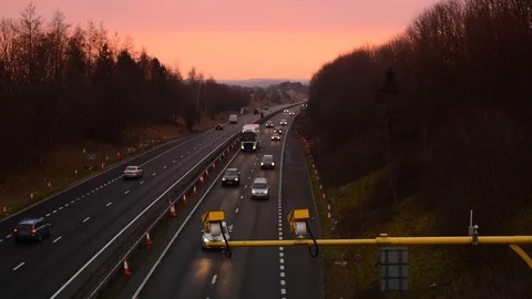 Time lapse traffic passing warning sign of average speed cameras uk Stock Footage 88084359