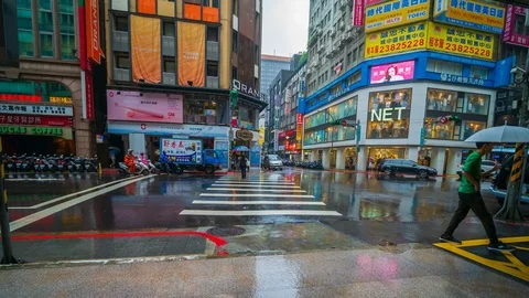 Time-lapse of Traffic on road with falling rain in Ximen district, Taipei , Taiw Stock Footage 124618428