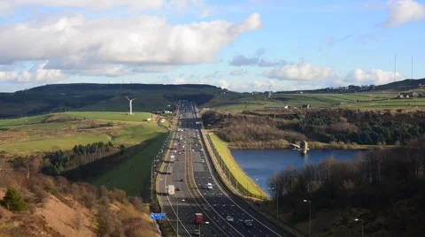Time lapse traffic by windmills  on m62 motorway united kingdom Stock Footage 59910674