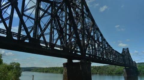 Time Lapse of Train Crossing Bridge from the River Stock Footage 58011435