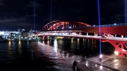 Time lapse of trains running over a bridge at night in Kyoto Stock Footage 254807367
