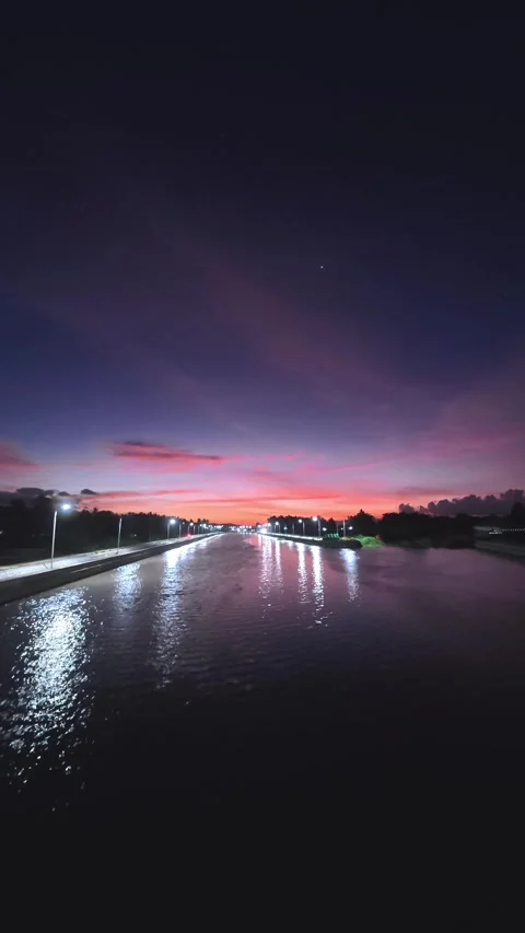 Time-lapse of Tranquil River Sunset with Reflections at Night Stock Footage 308394200