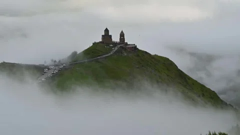 Time-lapse of Trinity Church in Kazbegi Georgia with clouds movement Stock Footage 248614035