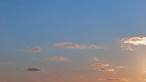 Time lapse of twilight blue sky with moving soft little clouds and sun beams Stock Footage 169050346